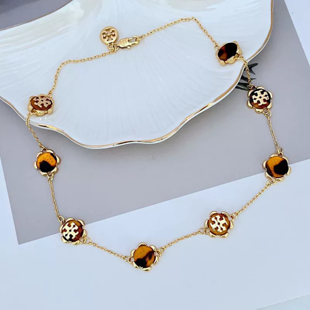 Tory Burch Inlaid Resin Amber Lady Metal Necklace